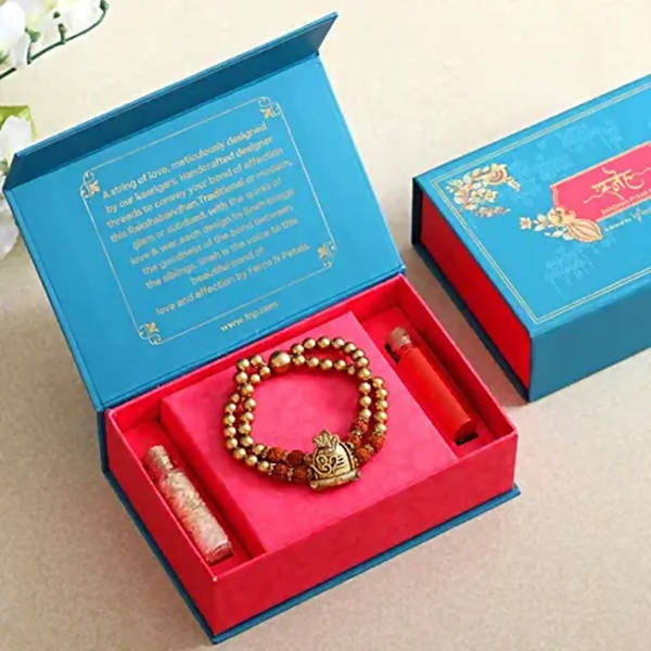 Om Pearl Bracelet Rakhi & Kaju Katli Box - Distacart